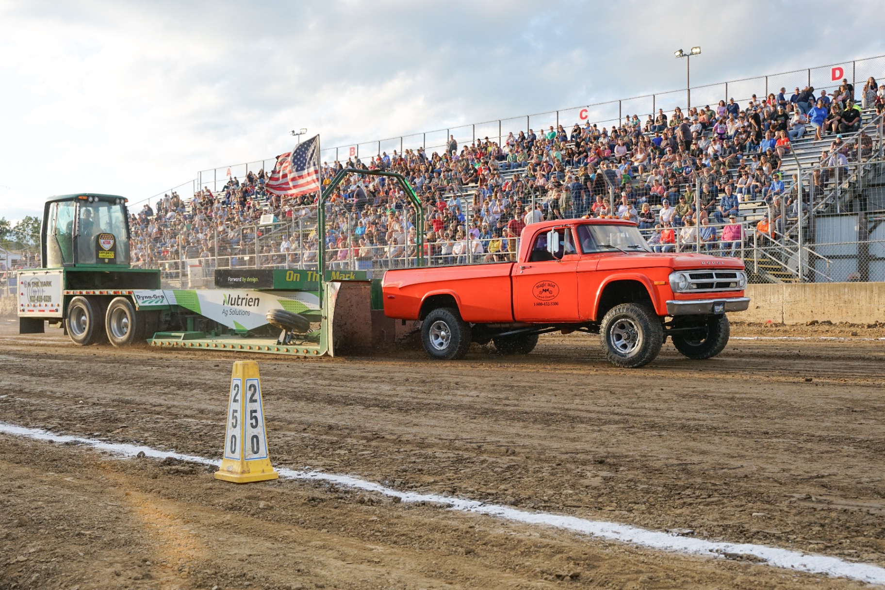 Demolition derby cars colliding under grandstand lights